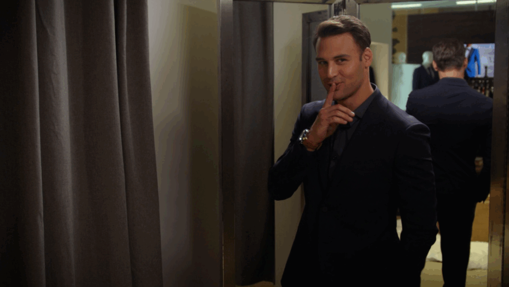 Ryan Guzman as Eddie Diaz, wearing a suit and shushing the camera.